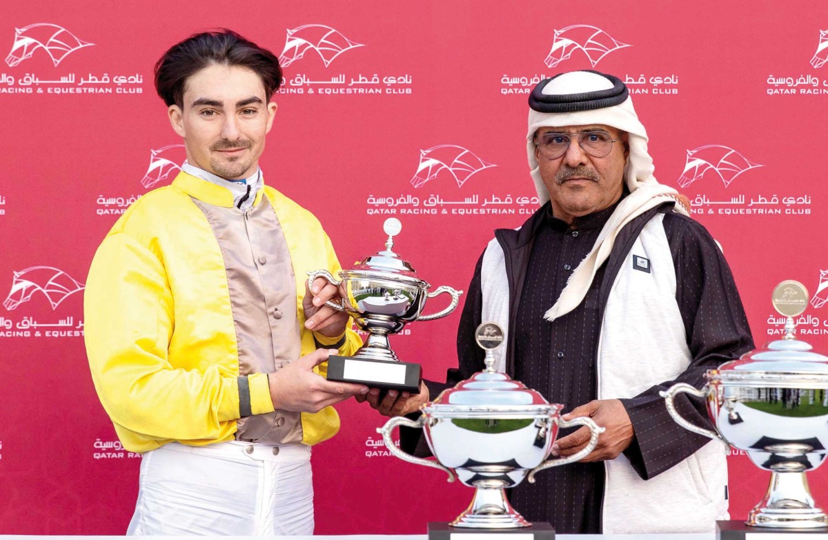 QREC Racing Manager Abdulla Rashid Al Kubaisi hands trophy to jockey Jefferson Smith. PICS: Juhaim/QREC