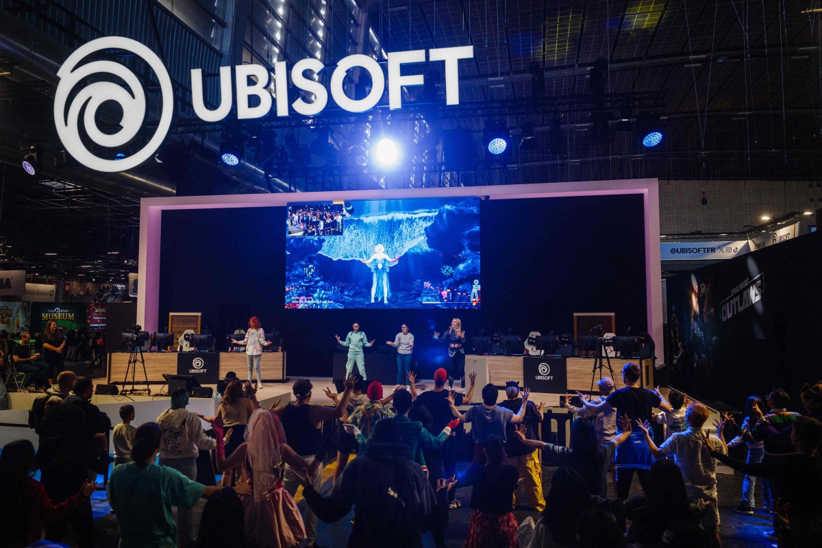 Visitors dance at the Ubisoft stand during the Paris Games Week fair in Paris, on October 23, 2024. Photo by Dimitar DILKOFF / AFP