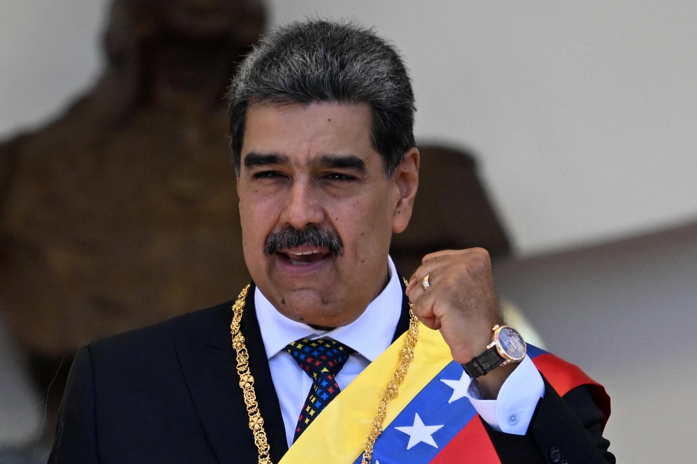  Venezuela's President Nicolas Maduro gestures as he leaves the Capitolio -home of the National Assembly- after taking the oath during the presidential inauguration in Caracas on January 10, 2025. (Photo by Juan Barreto / AFP)
