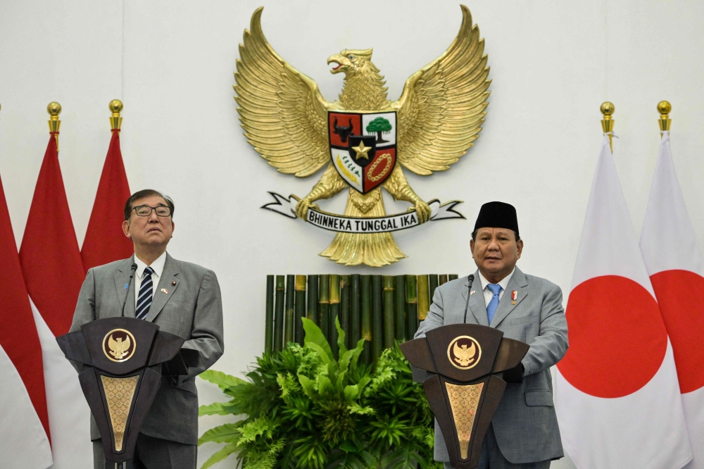 Indonesia's President Prabowo Subianto (R) and Japan's Prime Minister Shigeru Ishiba give a press statement following their meeting at the presidential palace in Bogor, West Java, on January 11, 2025. (Photo by Bay Ismoyo / AFP)