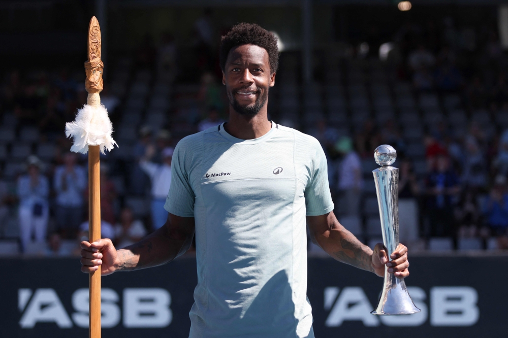 Gael Monfils of France poses with the trophy as he celebrates his win over Zizou Berges of Belgium following their men's singles final match at the ATP Auckland Classic tennis tournament in Auckland on January 11, 2025. (Photo by Michael Bradley / AFP)