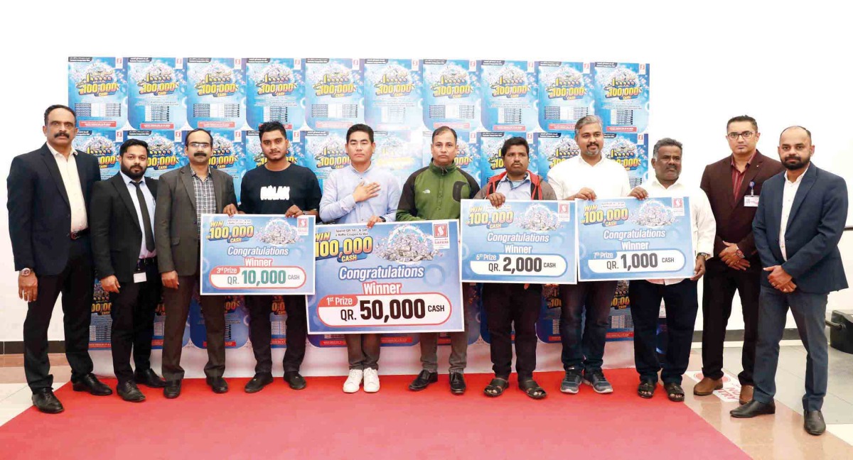 Safari Hypermarket officials with the winners during the prize presentation.