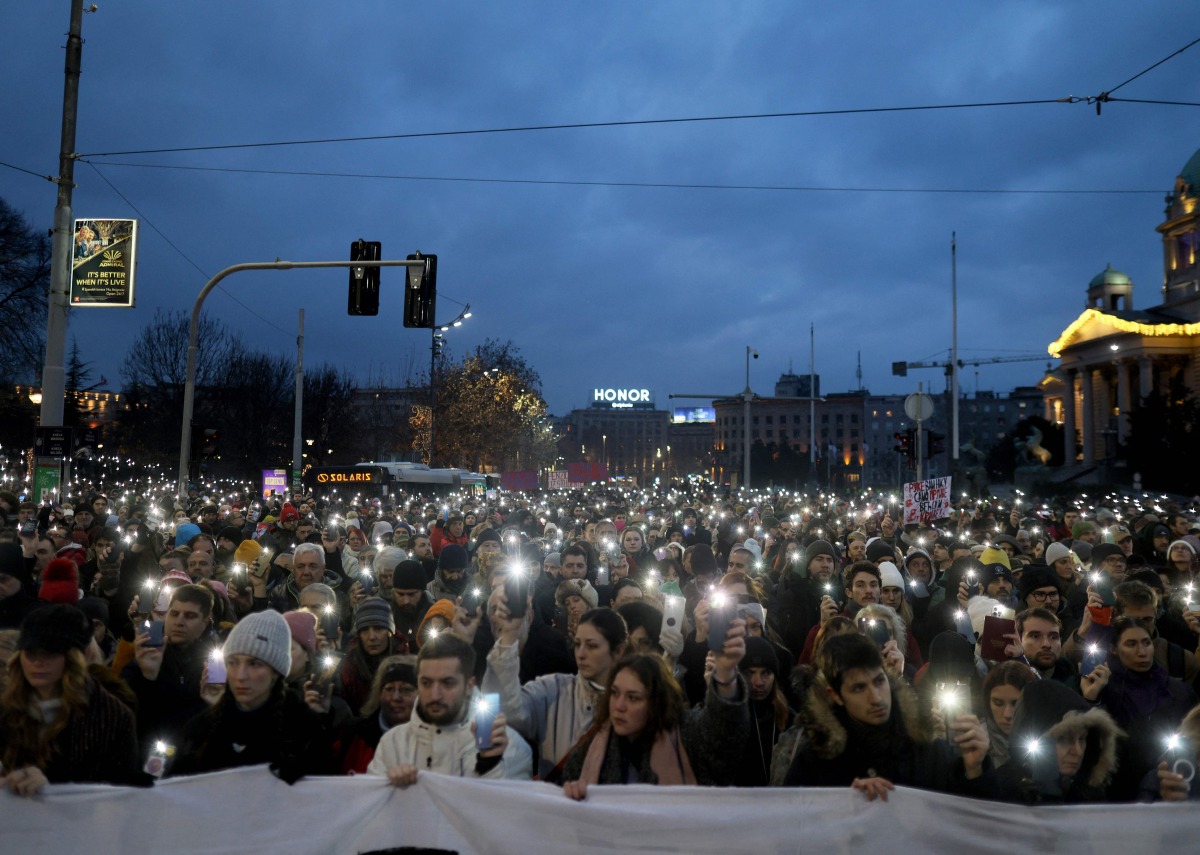 Demonstrators and students walk past Serbia's Constitutional Court building during a protest to demand accountability for the Novi Sad railway station tragedy, in Belgrade, on January 12, 2025. (Photo by OLIVER BUNIC / AFP)
