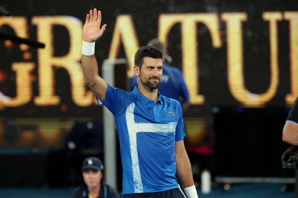 Serbia's Novak Djokovic celebrates his victory against USA's Nishesh Basavareddy during their men's singles match on day two of the Australian Open tennis tournament in Melbourne on January 13, 2025. (Photo by David Gray / AFP) 