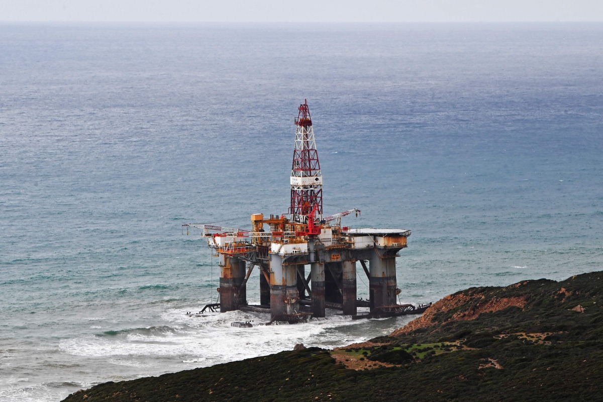 A general view of an oil platform that skidded is pictured on the beach of Hwaichat in Bizerte region, on January 13, 2025, after the traction cables connecting the platform to the ship that was pulling it broke, local media reported. (Photo by Fethi Belaid / AFP)