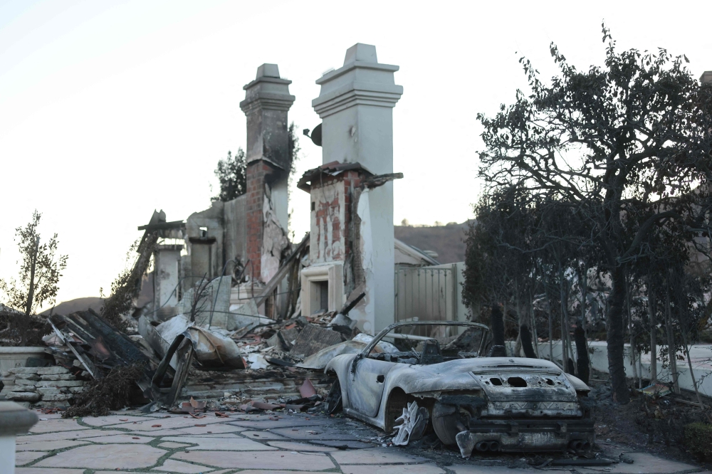 The entranceway to a damaged home is seen as the Palisades Fire continues to spread in Los Angeles, California, on January 12, 2025. (Photo by David Swanson / AFP)

