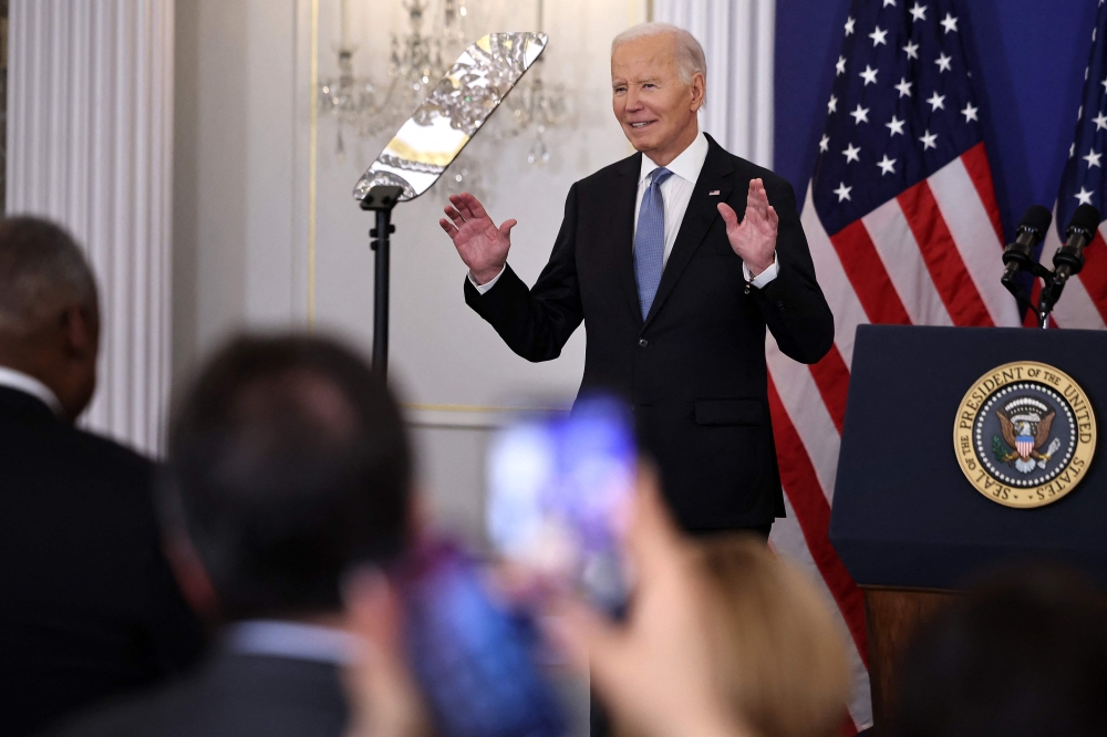 US President Joe Biden reacts to a standing ovation as he arrived to deliver a speech about his foreign policy achievements in the Ben Franklin Room at the State Department's Harry S Truman headquarters building in Washington, DC, on January 13, 2025.(Photo by Chip Somodevilla/Getty Images/AFP)