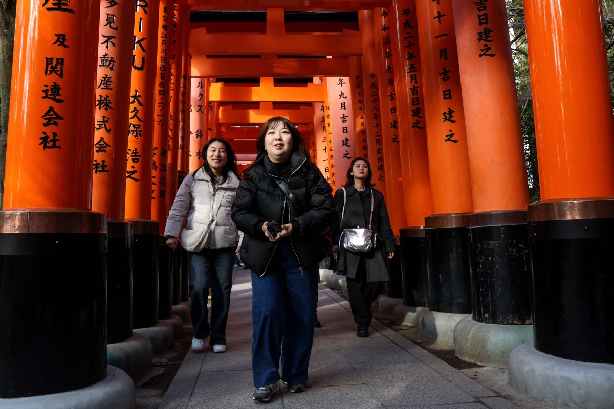 Tourists visit Fushimi Inari Shrine in the city of Kyoto on January 13, 2025. Photo by PAUL MILLER / AFP