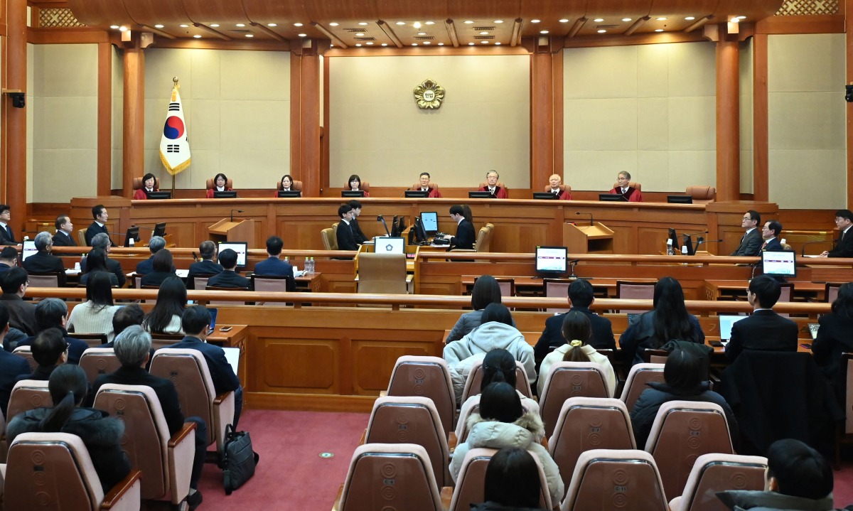 (L to R) Constitutional Court Judges Chung Kye-sun, Kim Bok-hyeong, Jung Jung-mi, Lee Mi-son, acting head of the Constitutional Court Moon Hyung-bae, Kim Hyung-du, Cheong Hyung-sik and Cho Han-chang attend the first formal hearing of the impeachment trial of suspended South Korean President Yoon Suk Yeol at the Constitutional Court in Seoul on January 14, 2025. Photo by KIM Min-Hee / POOL / AFP