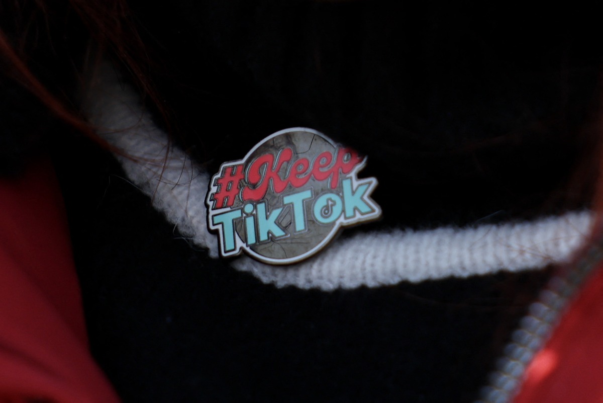 A detail view of the pin worn by TikTok educational influencer, Tiffany Cianci as she livestreams outside the U.S. Supreme Court Building while the court hears oral arguments on whether to overturn or delay a law that could lead to a ban of TikTok in the U.S., on January 10, 2025 in Washington, DC. Photo by Kayla Bartkowski / GETTY IMAGES NORTH AMERICA / Getty Images via AFP.