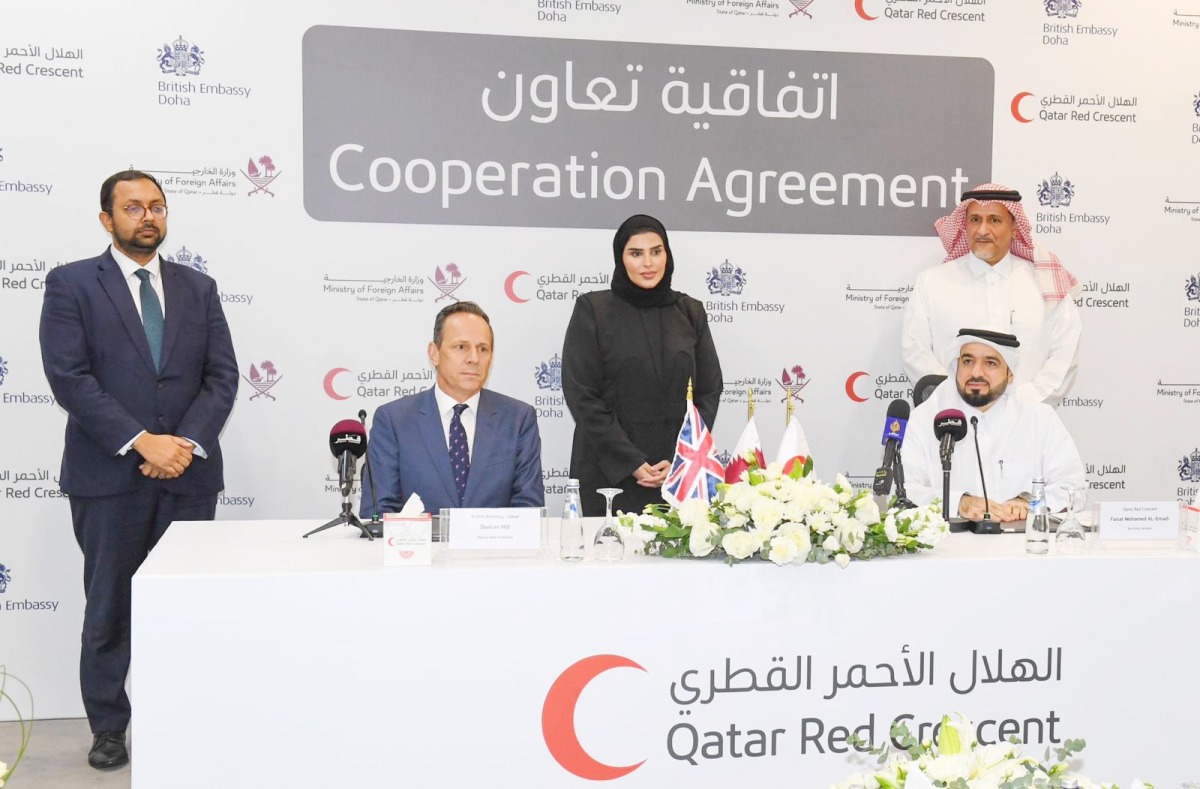 Minister of State for International Cooperation H E Maryam bint Ali bin Nasser Al Misnad (centre, back); UK Ambassador to Qatar H E Neerav Patel (left, back), and President of QRCS Yousef bin Ali Al Khater (right, back) at the agreement signing ceremony yesterday. 