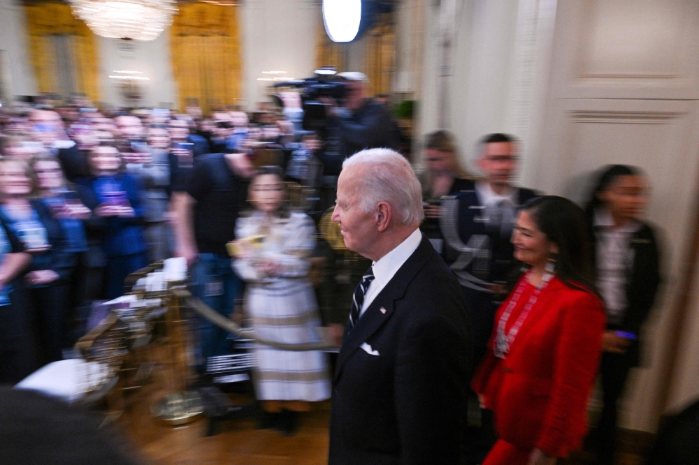 US President Joe Biden walks into the East Room of the White House to applause before signing proclamations to establish the Chuckwalla National Monument and the Sattitla Highlands National Monument in California, in Washington, DC, on January 14, 2025. (Photo by Roberto Schmidt / AFP)
 