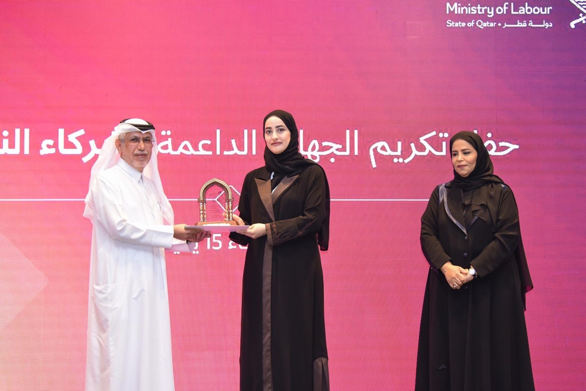 Assistant Undersecretary of the Ministry of Labour H E Sheikha Najwa bint Abdulrahman Al Thani honouring Deputy CEO of Dar Al Sharq and Editor-in-Chief of Al Sharq, Jaber Al Harami, during the ceremony in Doha yesterday.