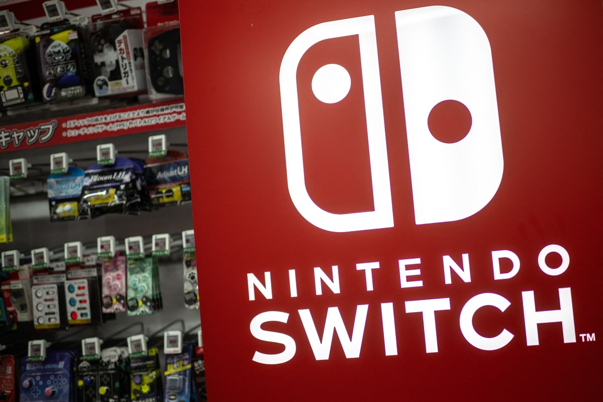 The Nintendo Switch logo is seen beside products for sale at the gaming section of a shop in Tokyo on January 16, 2025. Photo by Philip FONG / AFP