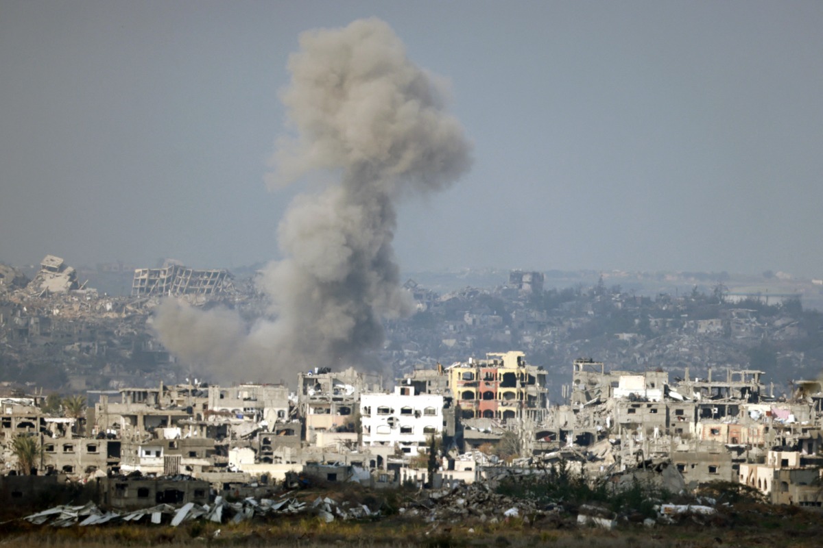 This picture taken from the Israeli side of the border with the Gaza Strip shows smoke plumes rising from explosions above destroyed buildings in the northern Gaza Strip on January 16, 2025, following the announcement of a ceasefire. Photo by Menahem KAHANA / AFP.