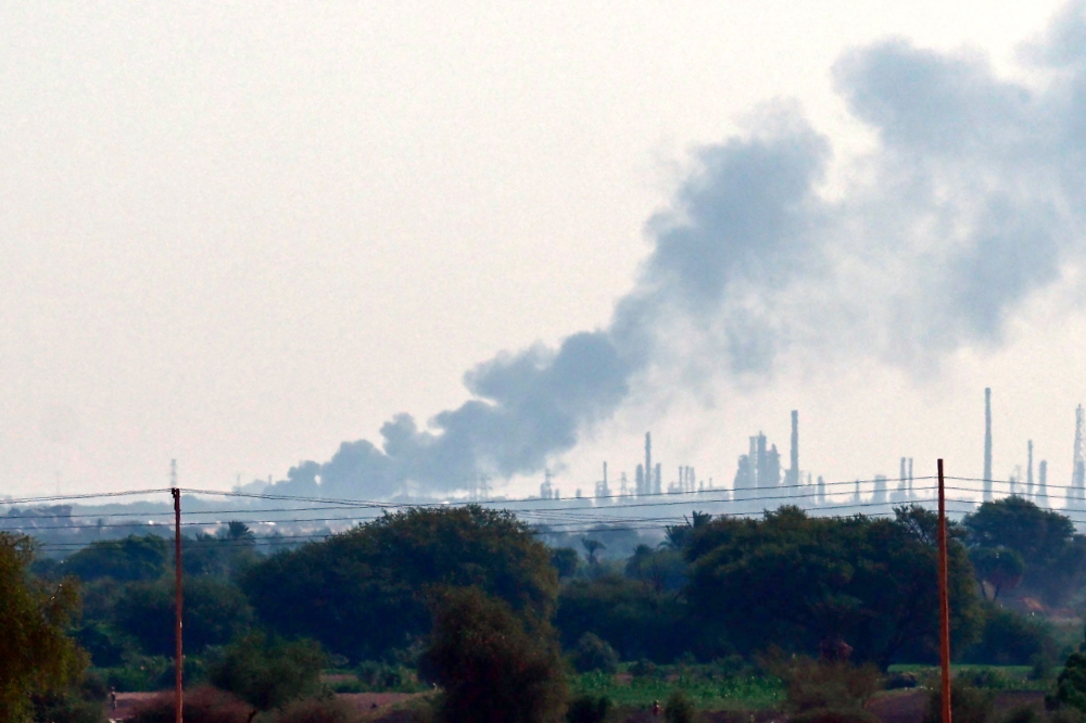 Smoke billows from al-Jaili oil refinery north of Omdurman, the Sudanese capital's twin city, during battles between the Sudanese military forces and paramilitary Rapid Support Forces (RSF), on January 15, 2025. (Photo by AFP)