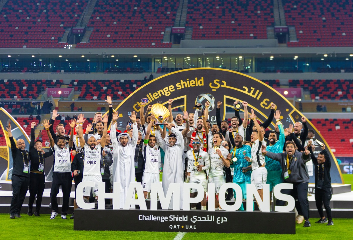 Shabab Al Ahli players and officials celebrate after winning the Challenge Shield yesterday.