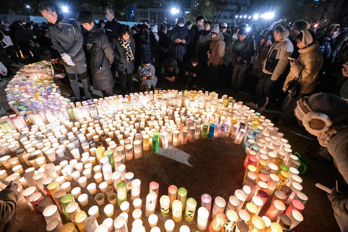 People take part in an early morning ceremony to remember the victims on the 30th anniversary of the 