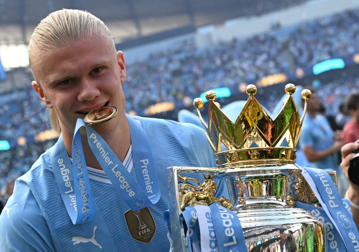 Manchester City's Norwegian striker #09 Erling Haaland poses with the Premier League trophy after the presentation ceremony following the English Premier League football match between Manchester City and West Ham United at the Etihad Stadium in Manchester, north west England, on May 19, 2024. Photo by Oli SCARFF / AFP