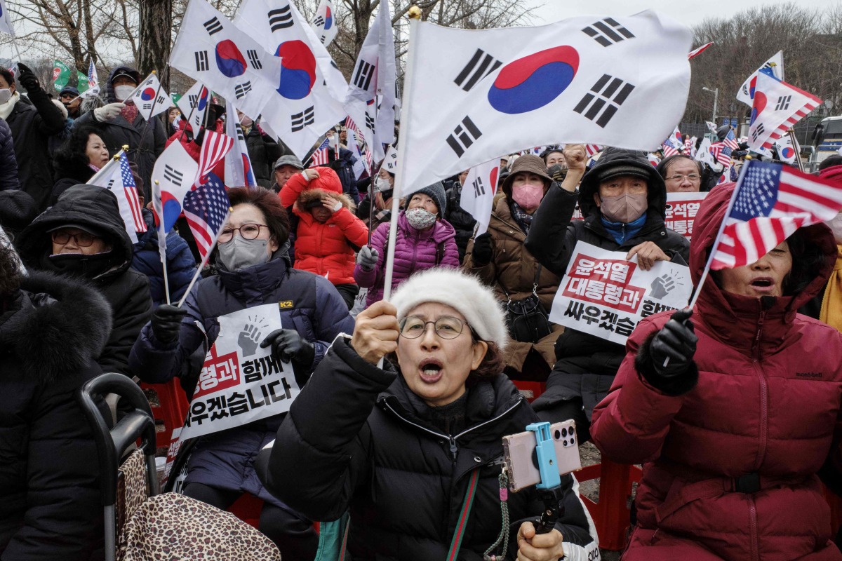 Supporters of impeached South Korean president Yoon Suk Yeol chant slogans during a rally outside the government complex building housing the Corruption Investigation Office for High-ranking Officials (CIO) in Gwacheon on January 16, 2025. Photo by ANTHONY WALLACE / AFP