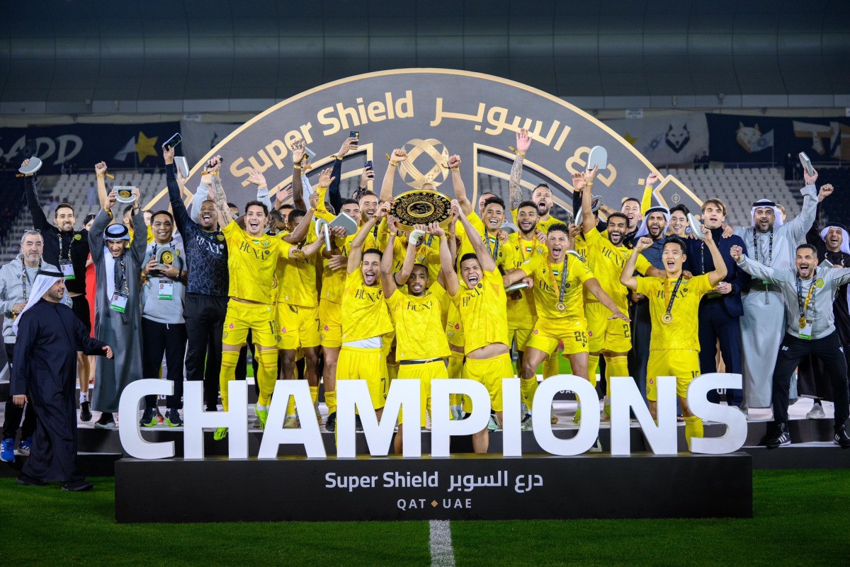 Al Wasl's players and officials celebrate with the Super Shield. 