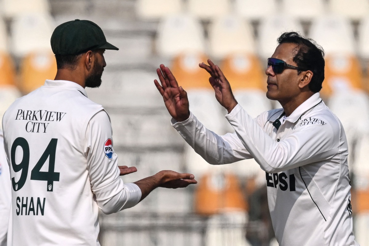 Pakistan's Noman Ali (R) celebrates with his captain Shan Masood after taking the wicket of West Indies' Kevin Sinclair during the second day of the first Test cricket match between Pakistan and West Indies at the Multan Cricket Stadium in Multan on January 18, 2025. (Photo by Aamir QURESHI / AFP)
