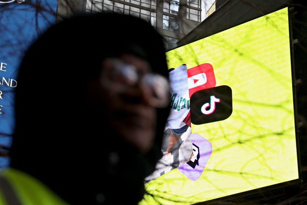 The Tik Tok Logo is displayed on a billboard at Times Square in New York City on January 17, 2025. (Photo by Leonardo Munoz / AFP)
