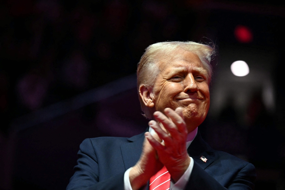 US President-elect Donald Trump reacts during a MAGA victory rally at Capital One Arena in Washington, DC, on January 19, 2025, one day ahead of his inauguration ceremony. (Photo by Jim Watson / AFP)