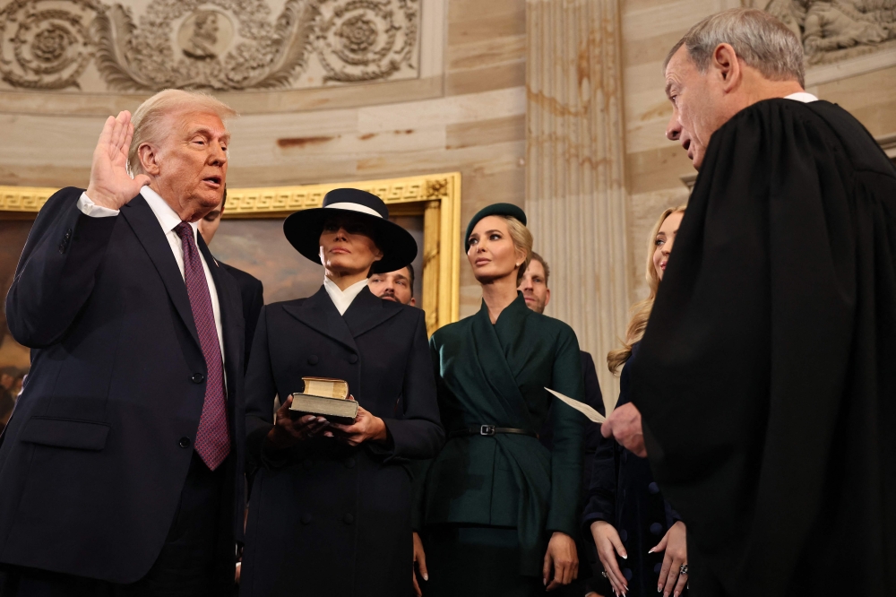 US President-elect Donald Trump takes the oath of office from US Supreme Court Chief Justice John Roberts during inauguration ceremonies in the Rotunda of the US Capitol on January 20, 2025 in Washington, DC. (Photo by Chip Somodevilla/Getty Images/AFP)