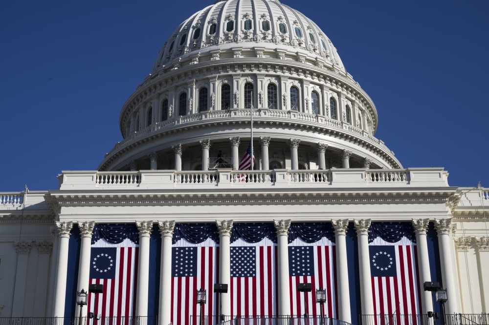 The Capitol is adorned with flags ahead of President-elect Donald Trump's second inauguration. (Photo by Marvin Joseph/The Washington Post)
