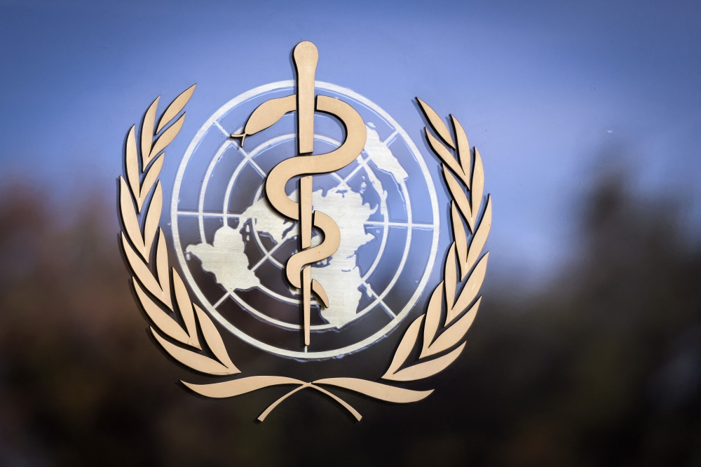 (Files) The logo of the World Health Organization (WHO) is pictured on the facade of the WHO headquarters on October 24, 2017 in Geneva. (Photo by Fabrice Coffrini / AFP)