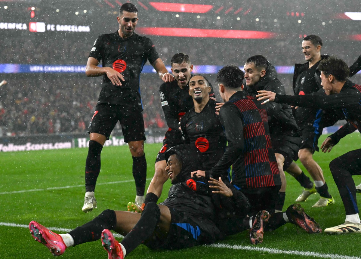 Barcelona's Brazilian forward #11 Raphinha (C) celebrates victory with teammates at the end of the UEFA Champions League, league phase football match between SL Benfica and FC Barcelona at Luz stadium in Lisbon on January 21, 2025. Barcelona won 4-5. (Photo by Patricia DE MELO MOREIRA / AFP)
