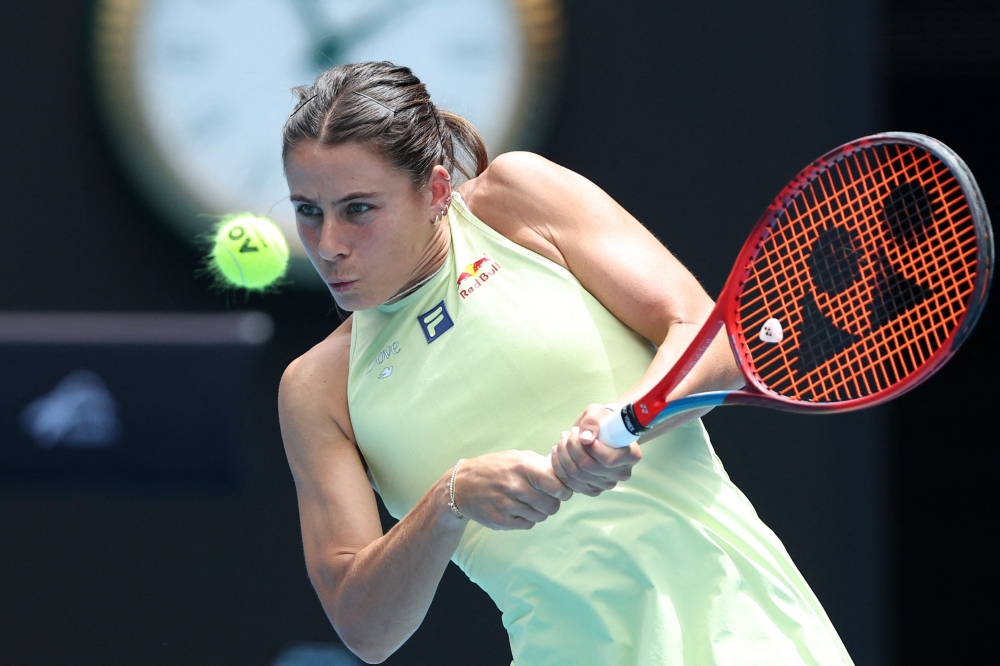 USA's Emma Navarro hits a return to Poland's Iga Swiatek during their women's singles quarter-final match on day eleven of the Australian Open tennis tournament in Melbourne on January 22, 2025. (Photo by Martin Keep / AFP) 