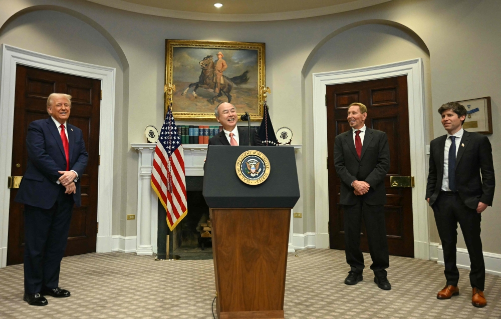 US President Donald Trump (L), Larry Ellison, Executive Charmain Oracle, and Sam Altman (R), CEO of Open AI listen to Masayoshi Son, Chairman and CEO of SoftBank Group Corp speak in the Roosevelt Room at the White House on January 21, 2025, in Washington, DC. (Photo by Jim Watson / AFP)
 