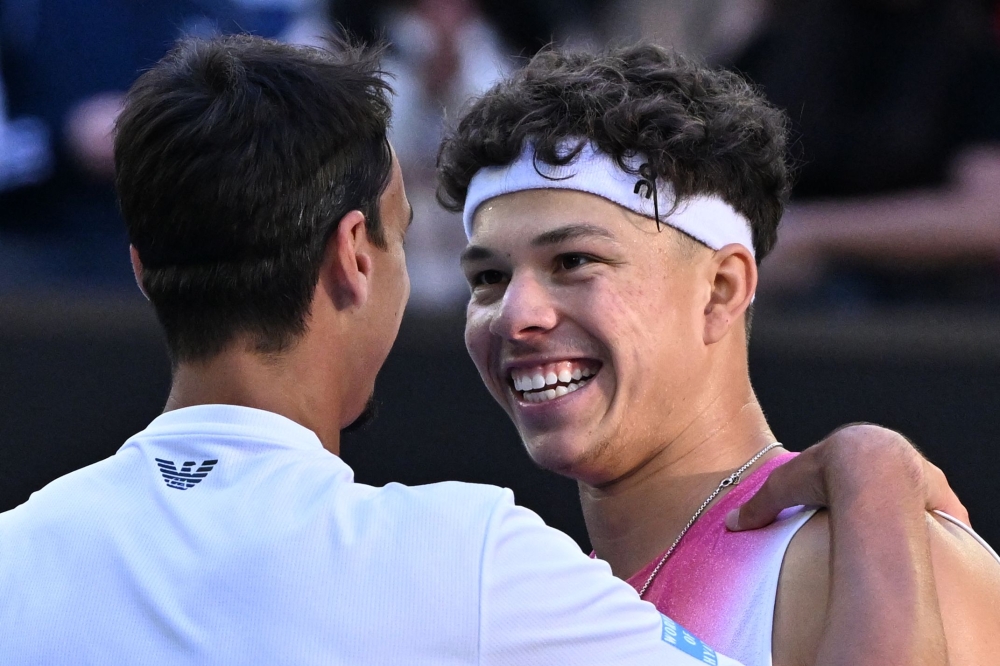 USA's Ben Shelton (R) greets Italy's Lorenzo Sonego (L) after his victory in their men's singles quarter-final match on day eleven of the Australian Open tennis tournament in Melbourne on January 22, 2025. (Photo by William West / AFP) /