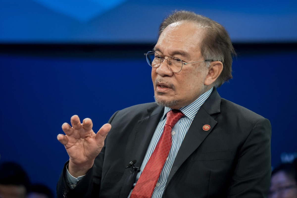 Malaysia's Prime Minister Anwar Ibrahim addresses a speech during the World Economic Forum (WEF) annual meeting in Davos on January 22, 2025. (Photo by FABRICE COFFRINI / AFP)
