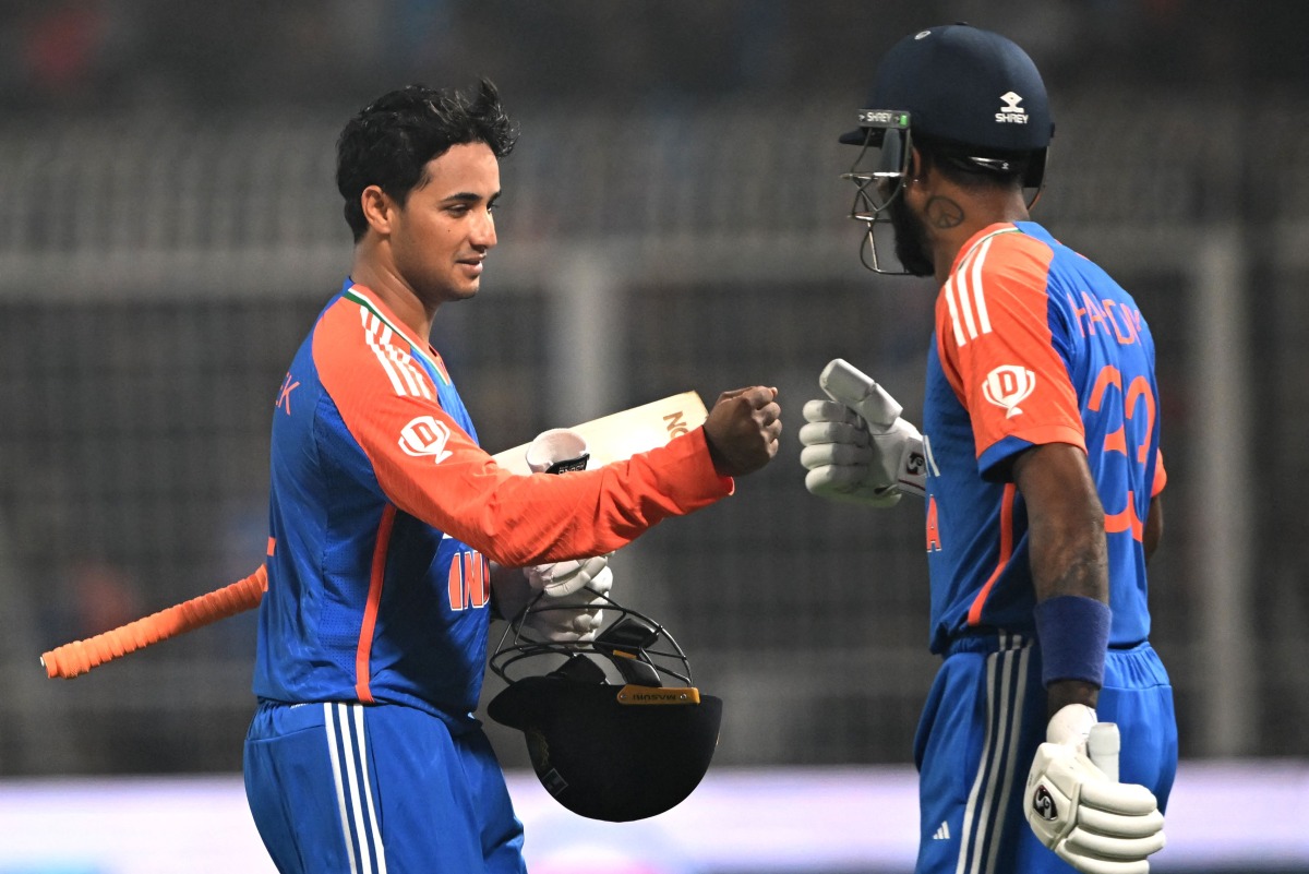 India's Abhishek Sharma (L) is congratulated by Hardik Pandya for his innings during the first Twenty20 international cricket match between India and England at the Eden Gardens in Kolkata on January 22, 2025. (Photo by DIBYANGSHU SARKAR / AFP)