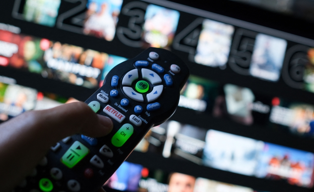 In this illustration photo taken on July 19, 2022 the Netflix logo is seen on a TV remote in Los Angeles. (Photo by Chris Delmas / AFP)