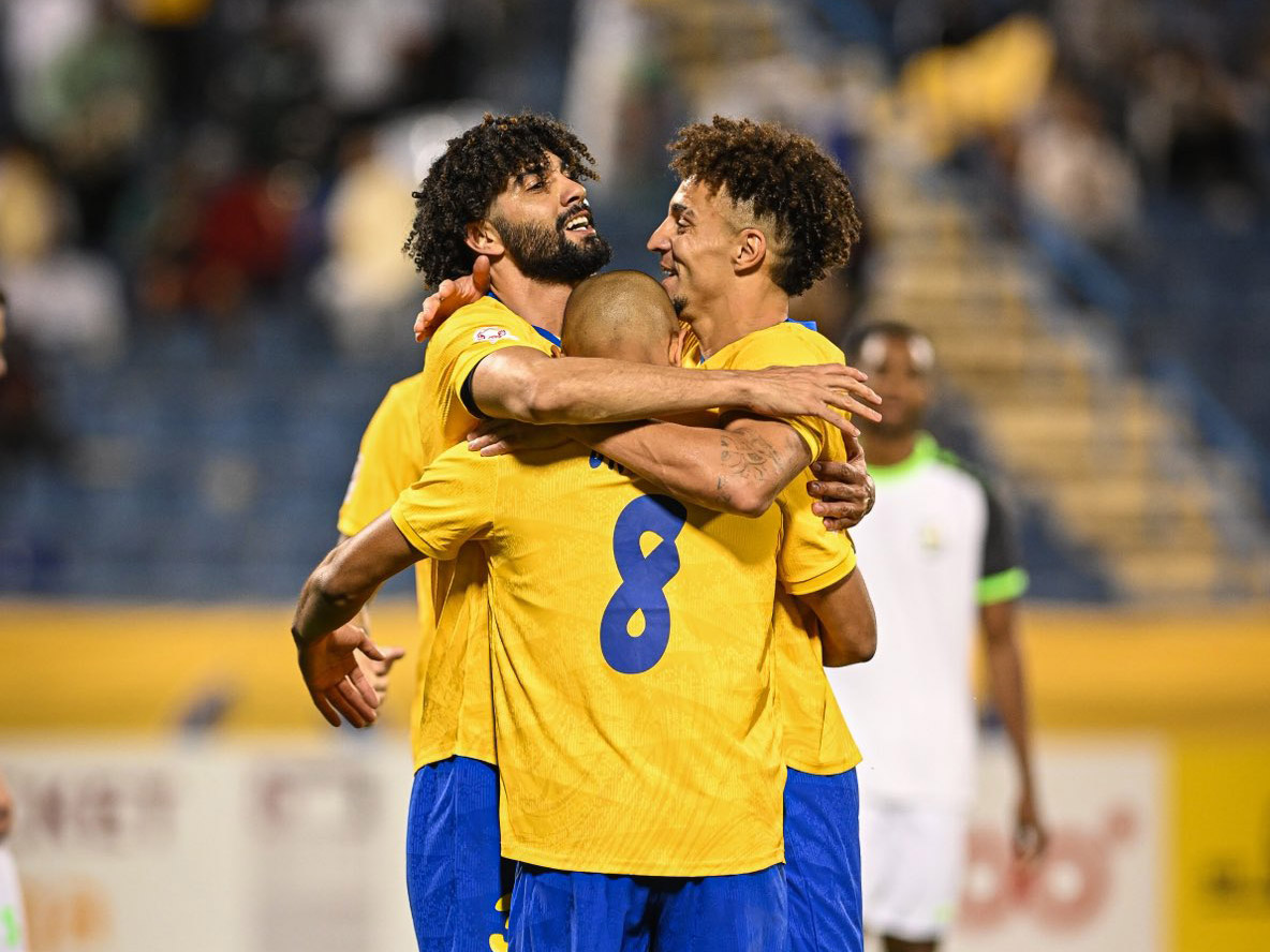 Al Gharafa's Ferjani Sassi (left) celebrates with teammates.