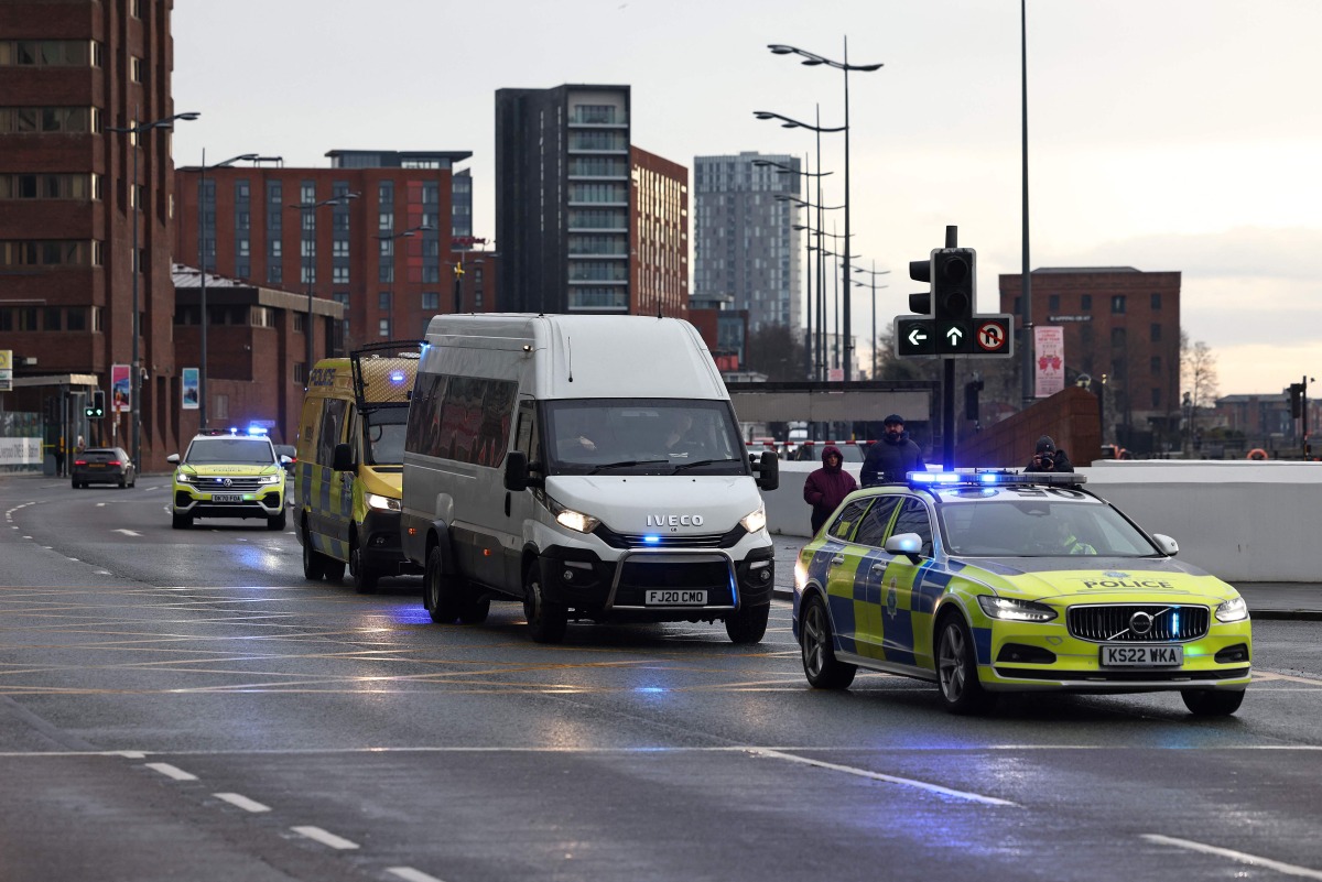 A Prison van escorted by police arrives at The Queen Elizabeth II Law Courts in Liverpool, north west England on January 23, 2025, ahead of the sentencing Southport attacker Axel Rudakubana. (Photo by Darren Staples / AFP)
