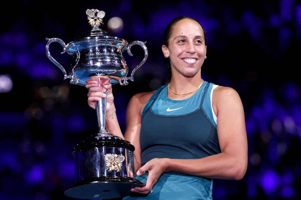 USA's Madison Keys celebrates with the Daphne Akhurst Memorial Cup after defeating Belarus' Aryna Sabalenka in Melbourne on January 25, 2025. (Photo by Martin Keep / AFP)