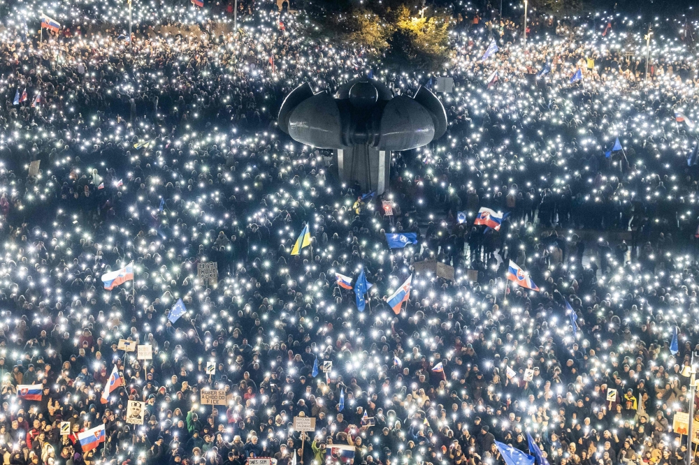 Hundreds of people hold up lights as they take part in an anti-government protest organized by political activists affiliated with the 