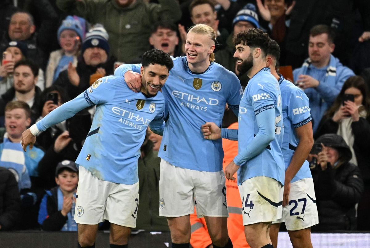 Manchester City's Norwegian striker #09 Erling Haaland celebrates scoring the team's second goal with Manchester City's Egyptian striker #07 Omar Marmoush (L) and Manchester City's Croatian defender #24 Josko Gvardiolduring the English Premier League football match between Manchester City and Chelsea at the Etihad Stadium in Manchester, north west England, on January 25, 2025. (Photo by Oli SCARFF / AFP)