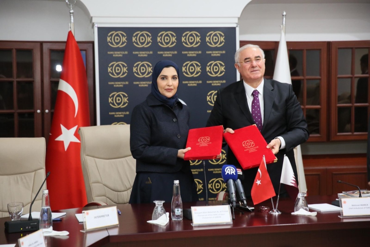 Chairperson of National Human Rights Committee H E Maryam bint Abdullah Al Attiyah and Chief Ombudsman of Turkiye H E Mehmet Akarca showing documents after signing the agreement.