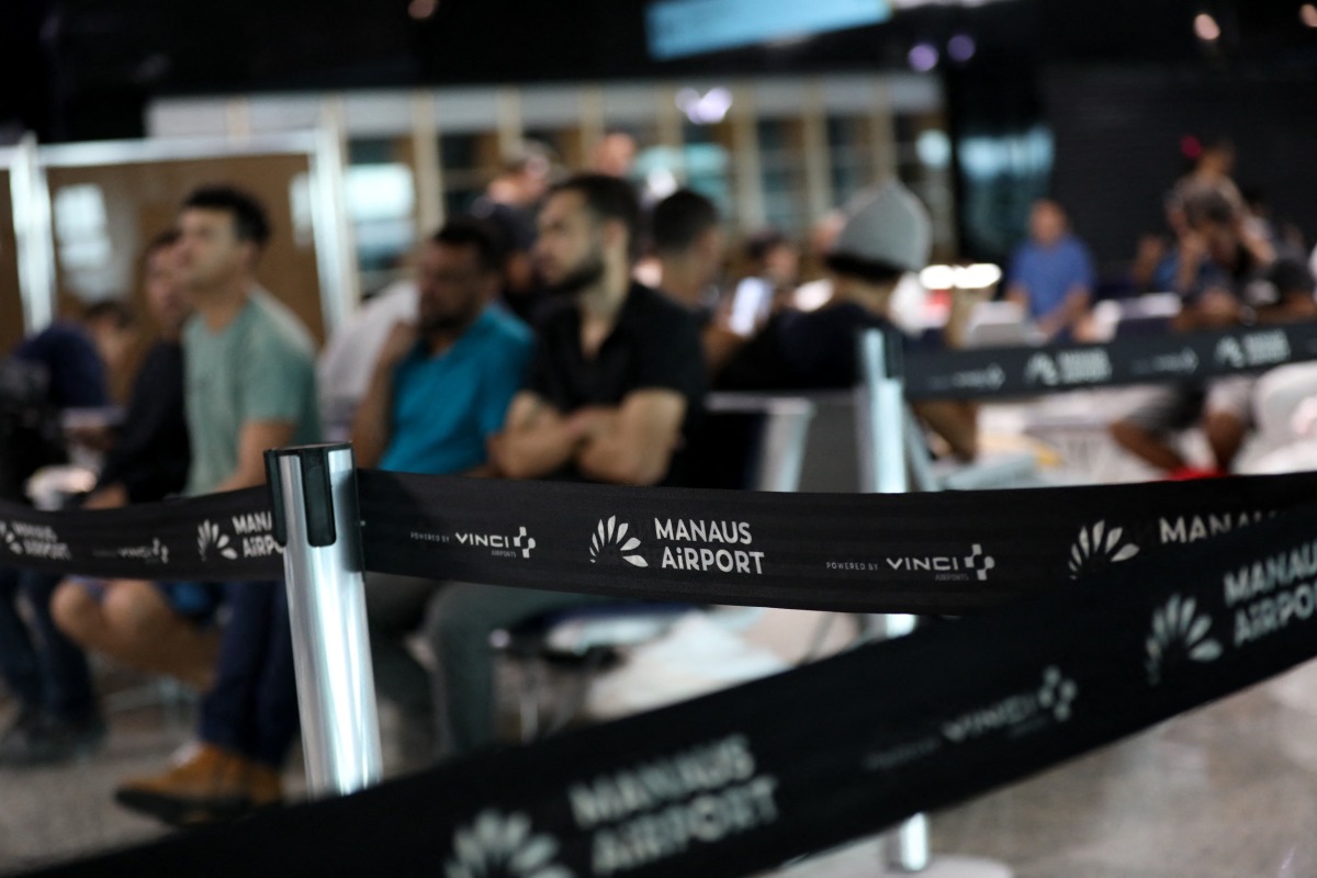 Brazilians who were deported from US wait at the departure lounge at Eduardo Gomes International Airport in Manaus, Amazonas state, on January 25, 2025. Photo by MICHAEL DANTAS / AFP.
