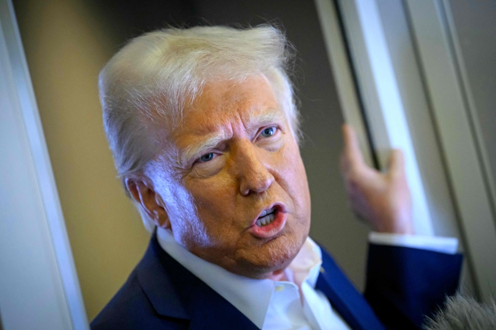 US President Donald Trump speaks with the press on board Air Force One after departing Las Vegas, Nevada, en route to Miami, Florida on January 25, 2025. (Photo by Mandel Ngan / AFP)