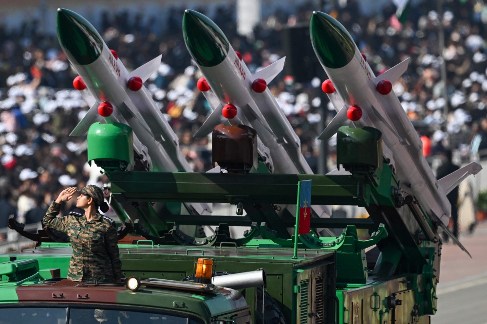 A soldier salutes next to an Akash missile system during country's 76th Republic Day parade in New Delhi on January 26, 2025. (Photo by Sajjad Hussain / AFP)