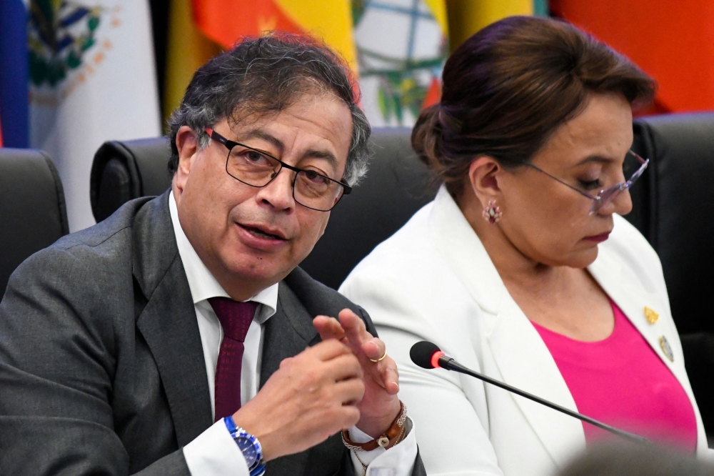 Colombia's President Gustavo Petro (L) speaks next to Honduras' President Xiomara Castro during the CELAC Summit in Buccament Bay, Saint Vincent and the Grenadines on March 1, 2024. (Photo by Randy Brooks / AFP)