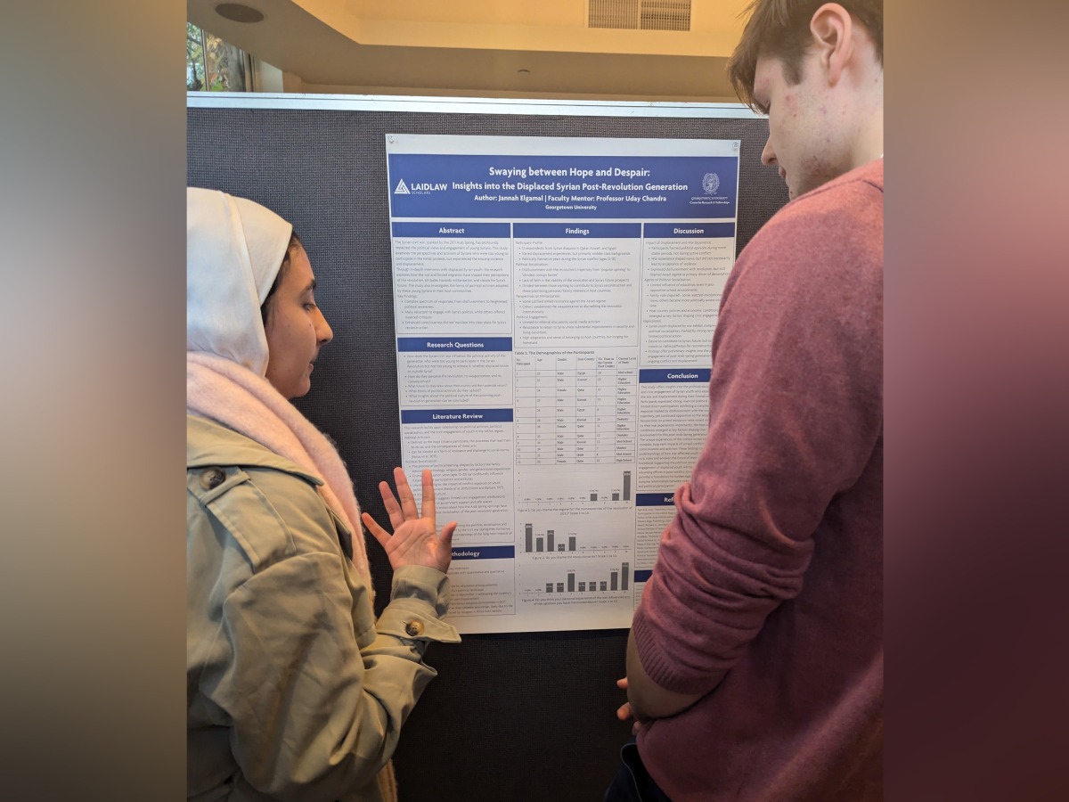 Jannah Elgamal (left) explaining her research.