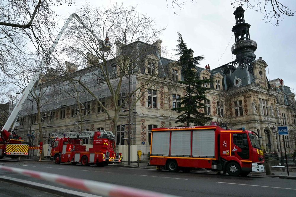 Firefighters vehicles are parked next to the townhall of the 12th district of Paris, on January 27, 2025, after it was hit by a spectacular fire. (Photo by Bertrand Guay / AFP)
 